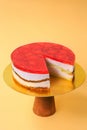 Sliced Birthday cake on the wooden cake stand. Beautiful sponge cake on the paper background. Copy space. Food photography for