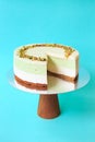 Sliced Birthday cake on the wooden cake stand. Beautiful sponge cake on the paper background. Copy space. Food photography for