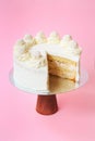 Sliced Birthday cake on the wooden cake stand. Beautiful sponge cake on the paper background. Copy space. Food photography for