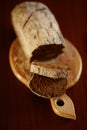 Sliced black bread on the wooden board and dark table Royalty Free Stock Photo