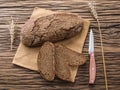 Sliced black bread on the wooden plank.