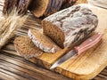 Sliced black bread on the wooden plank.