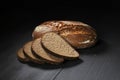 Sliced black bread on wooden table Royalty Free Stock Photo