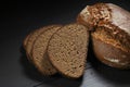 Sliced black bread on wooden table Royalty Free Stock Photo