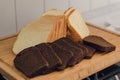 sliced black rye and white bread on a cutting board on the plate. Royalty Free Stock Photo
