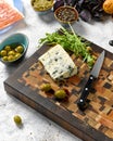 Sliced blue cheese and olives with arugula Royalty Free Stock Photo