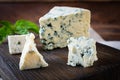 Sliced blue cheese on wooden background. Tasty dorblue on cutting board Royalty Free Stock Photo