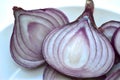 Sliced blue onion on a white plate close-up Royalty Free Stock Photo