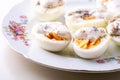 Sliced boiled eggs with mayonnaise and pepper in white plate isolated Royalty Free Stock Photo