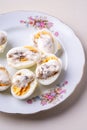 Sliced boiled eggs with mayonnaise and pepper in white plate isolated Royalty Free Stock Photo