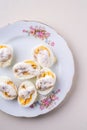 Sliced boiled eggs with mayonnaise and pepper in white plate isolated Royalty Free Stock Photo