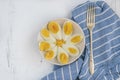 Sliced boiled eggs on white plate on wooden background for breakfast Royalty Free Stock Photo