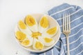 Sliced boiled eggs on white plate on wooden background for breakfast Royalty Free Stock Photo