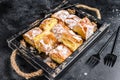 Sliced Bougatsa pie pastry with semolina custard cream. Black background. Top view