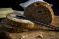 Sliced bread with butter. Dark background