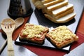 Sliced bread loaf with pizza toppings made of cheese, pepperoni and tomato sauce