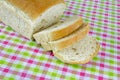 Sliced bread with olives on colorful table cloth background