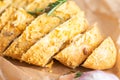 Sliced bread sprinkled with cheese and herbs Royalty Free Stock Photo