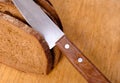 Sliced bread on a wooden cutting board and knife
