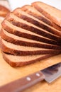 Sliced bread on a wooden cutting board and knife Royalty Free Stock Photo