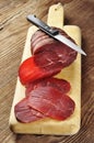 Sliced bresaola on a cutting board
