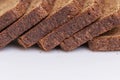 Sliced brown bread. Close-up. White background. Space for text Royalty Free Stock Photo