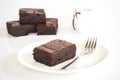 Sliced brownies on white plate. Served with chocolate fudge topp Royalty Free Stock Photo