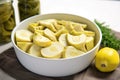 sliced canned artichoke hearts arranged in a white bowl