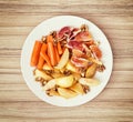 Sliced carrots, apple, grapefruit, oranges and walnuts on a whit Royalty Free Stock Photo