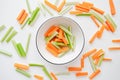 Sliced carrots and celery in a white bowl, healthy food background Royalty Free Stock Photo