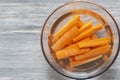 Sliced carrots soaking in a glass bowl of water. Royalty Free Stock Photo