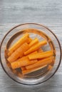 Sliced carrots soaking in a glass bowl of water. Royalty Free Stock Photo