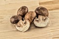 Sliced champignons large king mushrooms whole and half on a wooden background Royalty Free Stock Photo