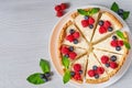 Sliced cheesecake with fresh berries on the white plate - healthy organic dessert. Classic New York cheese cake