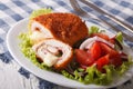 sliced Chicken cordon bleu schnitzel and salad closeup. horizontal