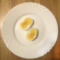 Sliced chicken egg on a white plate Royalty Free Stock Photo