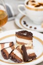 Sliced chocolate cake, cofee and cognac on background