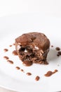 Sliced chocolate cup cake muffing with topping melting chocolate cream above white marble background