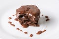 Sliced chocolate cup cake muffing with topping melting chocolate cream above white marble background