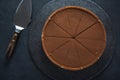 Sliced chocolate tort on dark background