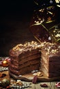 Sliced Christmas chocolate cake with nuts, New Year`s dinner, to