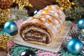 sliced christmas poppy seed cake with icing and snowflake sprinkles