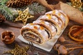 sliced christmas poppy seed cake with icing and snowflake sprinkles