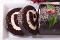 Sliced Christmas yule log cake on plate, above Royalty Free Stock Photo