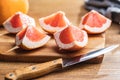 Sliced citrus fruit. Chopped fresh grapefruit on cutting board Royalty Free Stock Photo