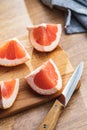 Sliced citrus fruit. Chopped fresh grapefruit on cutting board Royalty Free Stock Photo