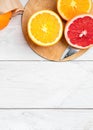 Sliced citrus fruits on a wooden table, orange and grapefruit