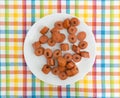 Sliced cooked hot dogs on a white plate