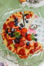 Sliced Crape Cake on top with Mixed Berries and Strawberry Sauce