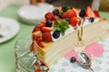 Sliced Crape Cake on top with Mixed Berries and Strawberry Sauce Royalty Free Stock Photo